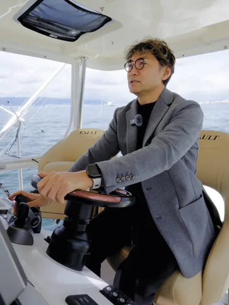 クルーザーを運転する収録中の曽我さん。マリン業界で日本一有名なYouTubeチャンネル「釣りバカ社長のGROOVY FISHING CHANNEL」を運営している